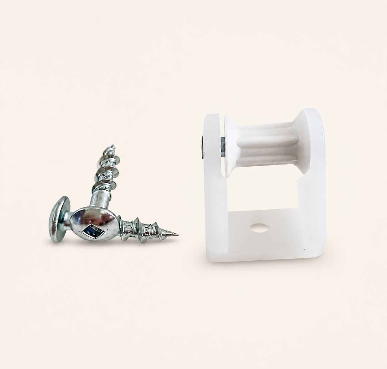 Silver screw-in fitting and white Roman blind pulley component